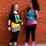 happy young females standing outdoors